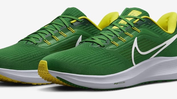 Side view of green and yellow Nike running shoes.
